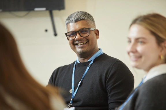 Man smiling with colleagues