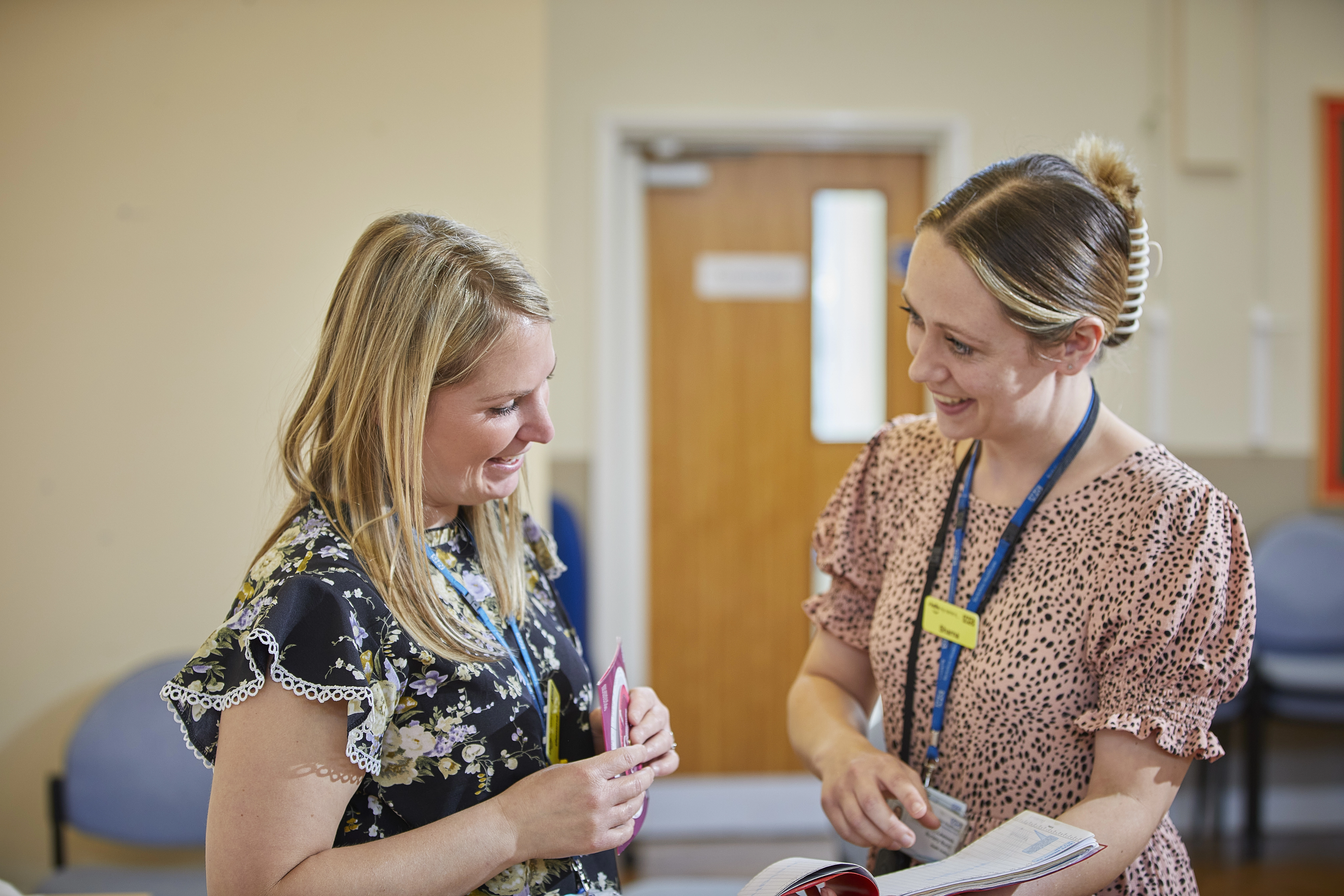 Two staff members looking at a file