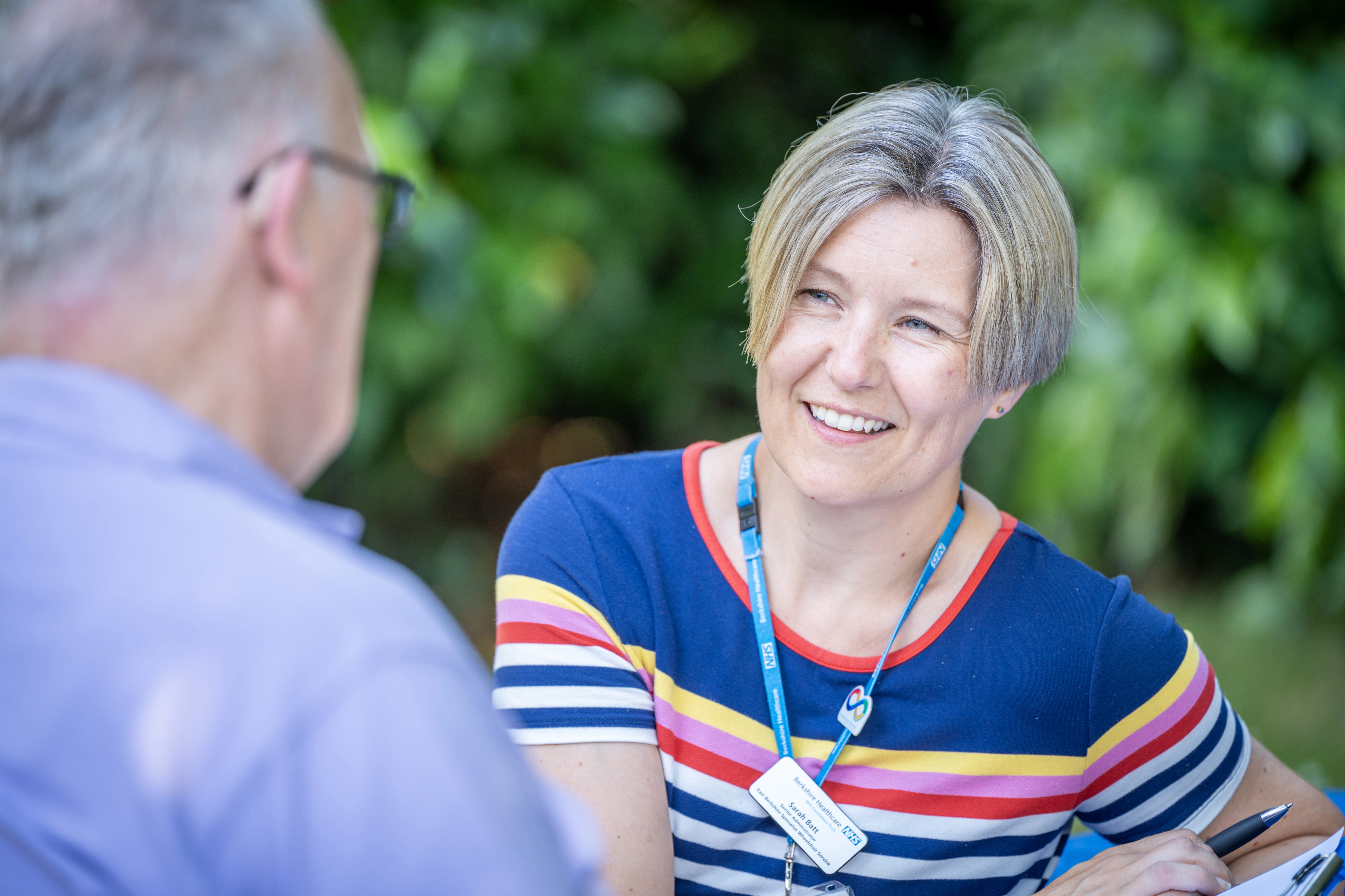 Staff member talking to man outside