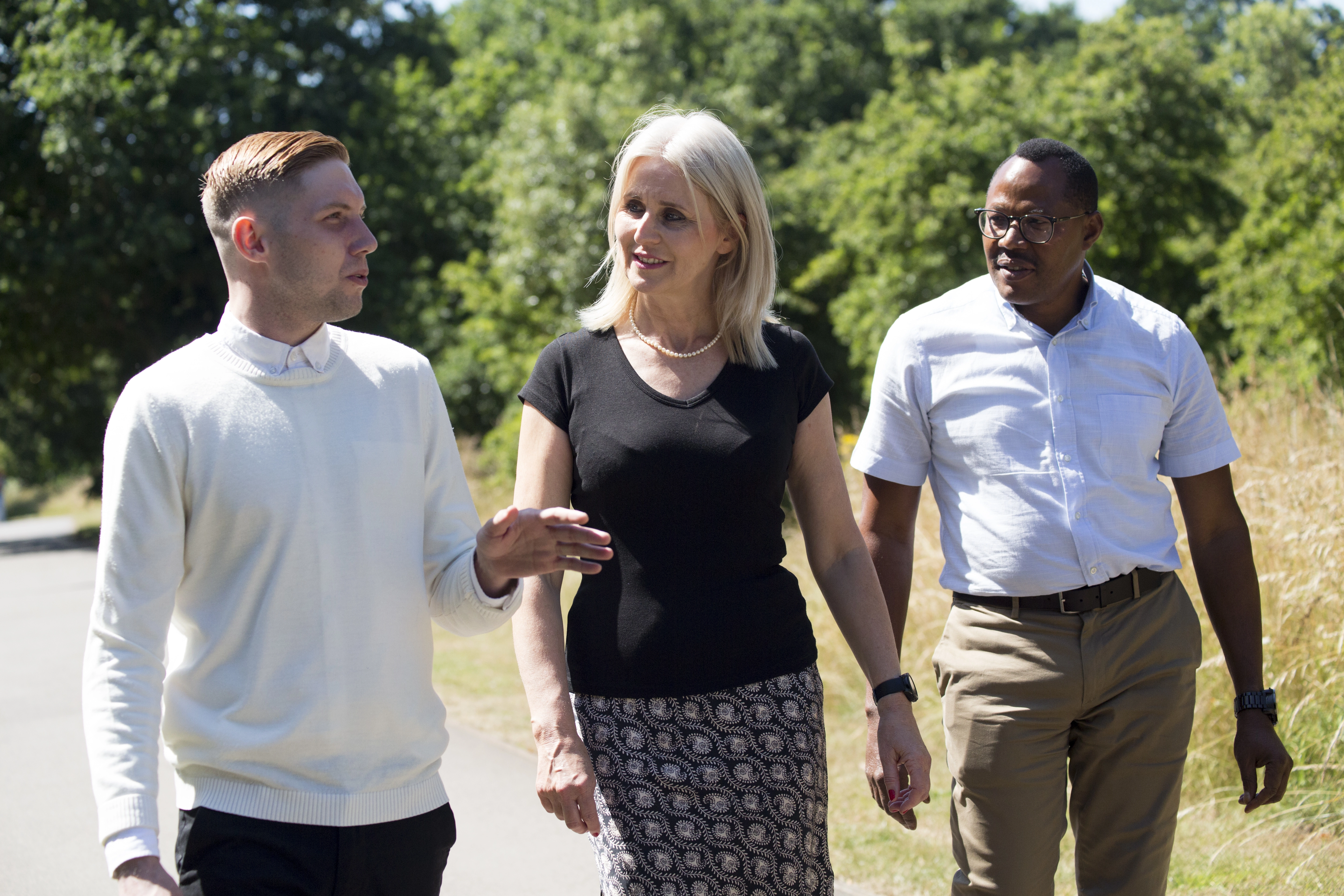 Three people on a walk outside