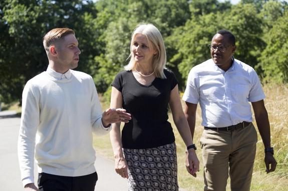 Three people on a walk outside